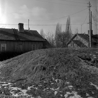 Zbliżenie na część, na której stała laweta z trumną Piłsudskiego. W tle jeden z domów na osiedlu domków fińskich.